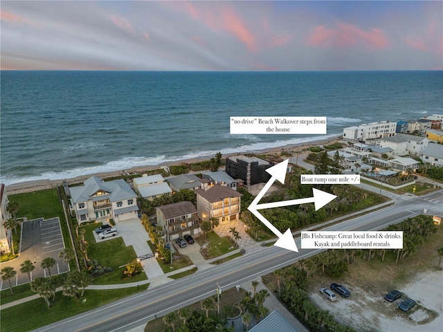 6771 Turtlemound Rd, New Smyrna Beach, FL 32169 - aerial view at dusk featuring a water view and a beach view