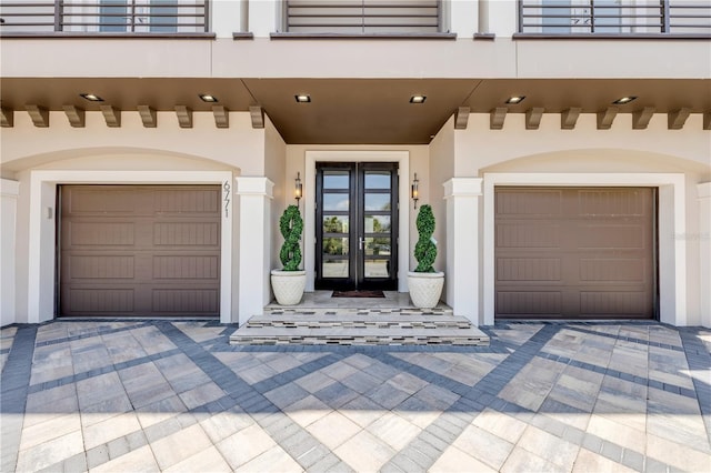 6771 Turtlemound Rd, New Smyrna Beach, FL 32169 - view of exterior entry with a balcony, stucco siding, and french doors