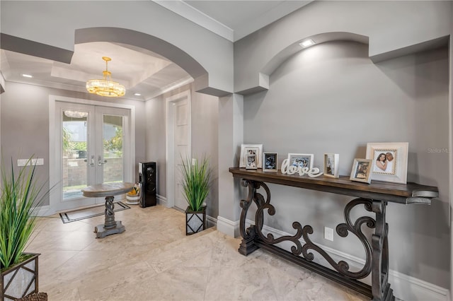 6771 Turtlemound Rd, New Smyrna Beach, FL 32169 - entrance foyer with arched walkways, french doors, crown molding, and a chandelier