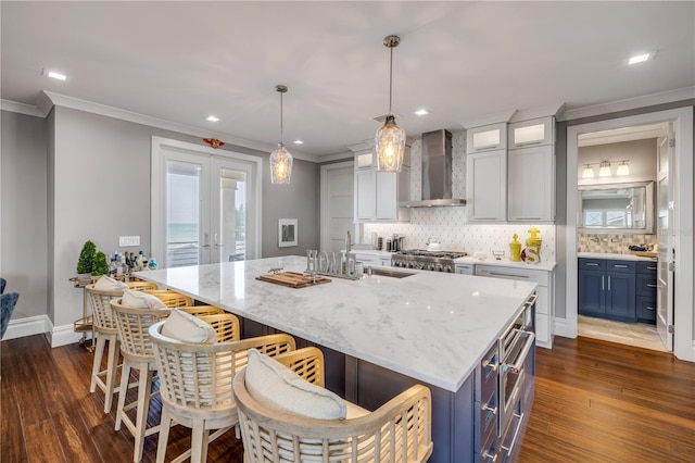 6771 Turtlemound Rd, New Smyrna Beach, FL 32169 - kitchen featuring a sink, crown molding, dark wood finished floors, wall chimney range hood, and decorative backsplash