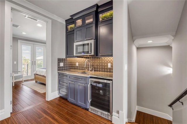 6771 Turtlemound Rd, New Smyrna Beach, FL 32169 - bar featuring stainless steel microwave, a sink, wine cooler, visible vents, and baseboards