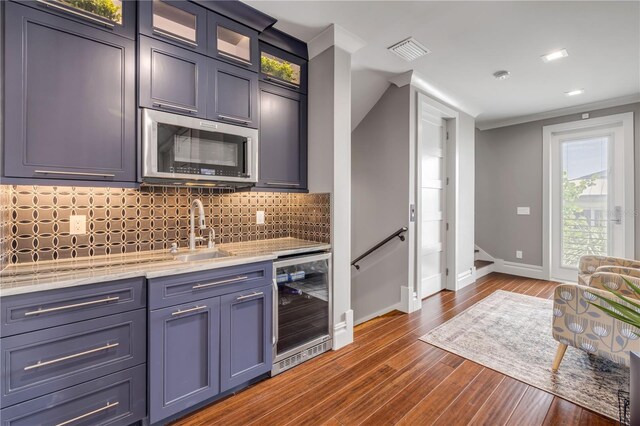 6771 Turtlemound Rd, New Smyrna Beach, FL 32169 - kitchen featuring wine cooler, baseboards, visible vents, a sink, and stainless steel microwave