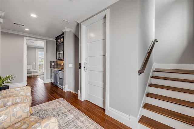 6771 Turtlemound Rd, New Smyrna Beach, FL 32169 - entryway featuring dark wood finished floors, visible vents, baseboards, and stairway