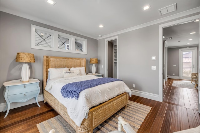 6771 Turtlemound Rd, New Smyrna Beach, FL 32169 - bedroom featuring wood finished floors, ornamental molding, visible vents, baseboards, and a spacious closet