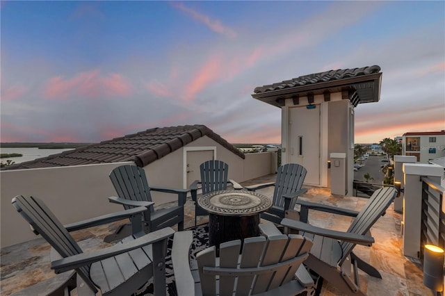 6771 Turtlemound Rd, New Smyrna Beach, FL 32169 - patio terrace at dusk featuring an outdoor fire pit