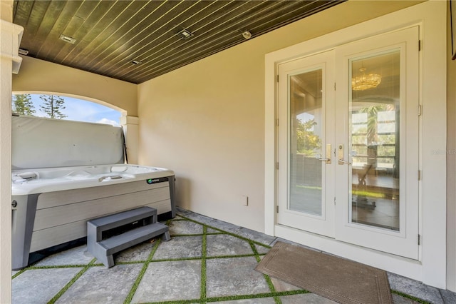 6771 Turtlemound Rd, New Smyrna Beach, FL 32169 - view of patio / terrace featuring a hot tub and french doors