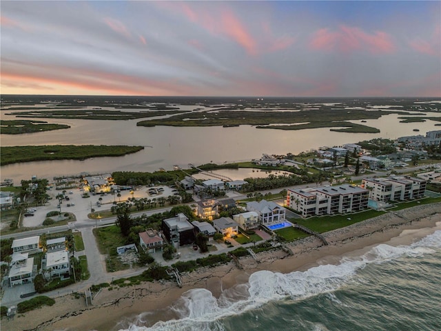 6771 Turtlemound Rd, New Smyrna Beach, FL 32169 - aerial view at dusk with a water view and a beach view