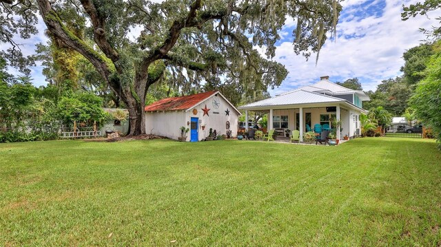 508 Faulkner St, New Smyrna Beach, FL 32168 - rear view of house featuring a patio and an outbuilding