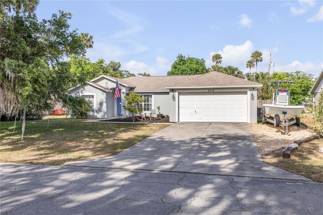 2713 Needle Palm Dr, Edgewater, FL 32141 - ranch-style home featuring an attached garage, stucco siding, concrete driveway, and a front yard