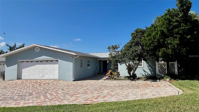 34 Richmond Dr, New Smyrna Beach, FL 32169 - ranch-style house with a garage, stucco siding, and driveway