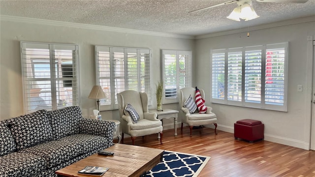 34 Richmond Dr, New Smyrna Beach, FL 32169 - living area with wood finished floors, a ceiling fan, crown molding, a textured ceiling, and baseboards