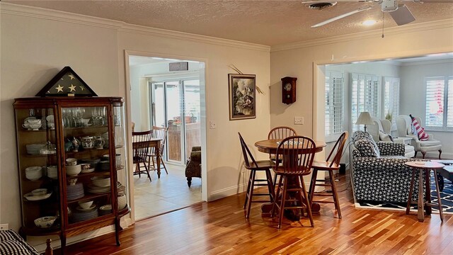 34 Richmond Dr, New Smyrna Beach, FL 32169 - dining room featuring light wood finished floors, ornamental molding, and ceiling fan