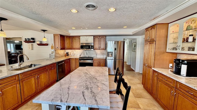34 Richmond Dr, New Smyrna Beach, FL 32169 - kitchen with brown cabinetry, stainless steel appliances, visible vents, and a sink