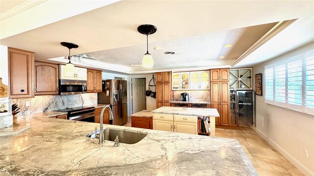 34 Richmond Dr, New Smyrna Beach, FL 32169 - kitchen with appliances with stainless steel finishes, decorative backsplash, a raised ceiling, and a sink