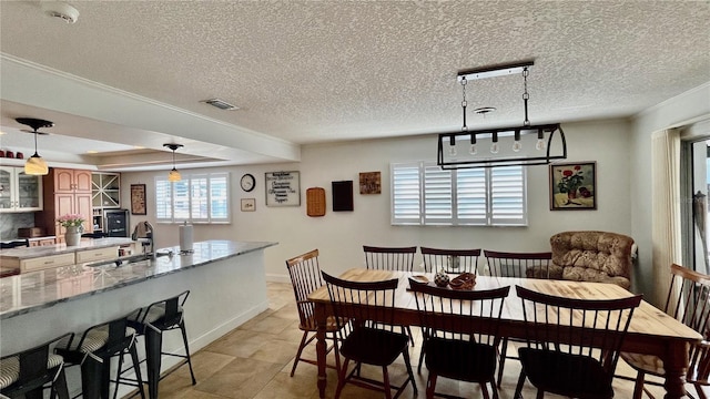 34 Richmond Dr, New Smyrna Beach, FL 32169 - dining area featuring a textured ceiling, visible vents, and baseboards