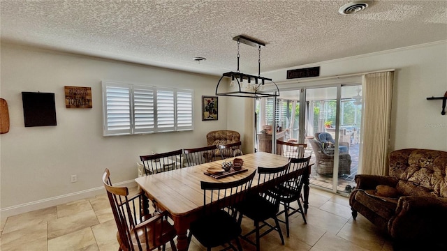 34 Richmond Dr, New Smyrna Beach, FL 32169 - dining space with a textured ceiling, visible vents, baseboards, and light tile patterned floors
