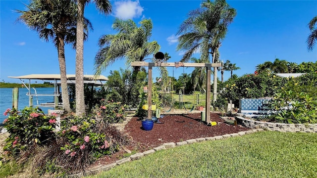34 Richmond Dr, New Smyrna Beach, FL 32169 - view of play area with a boat dock and boat lift