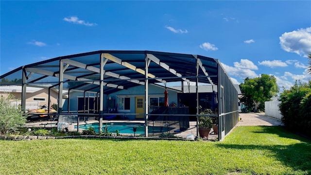 34 Richmond Dr, New Smyrna Beach, FL 32169 - rear view of house featuring a lawn, glass enclosure, and an outdoor pool