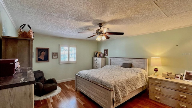 34 Richmond Dr, New Smyrna Beach, FL 32169 - bedroom featuring dark wood-style flooring, a textured ceiling, baseboards, and a ceiling fan
