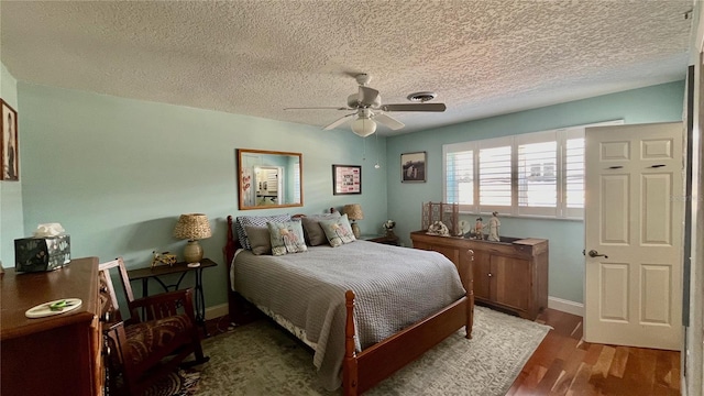34 Richmond Dr, New Smyrna Beach, FL 32169 - bedroom featuring a textured ceiling, wood finished floors, baseboards, and ceiling fan