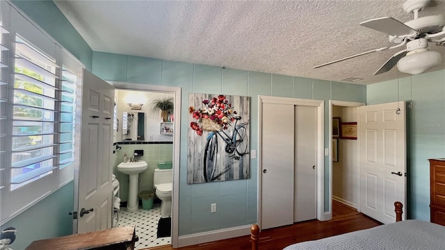 34 Richmond Dr, New Smyrna Beach, FL 32169 - bedroom with a ceiling fan, a sink, a closet, a textured ceiling, and ensuite bathroom