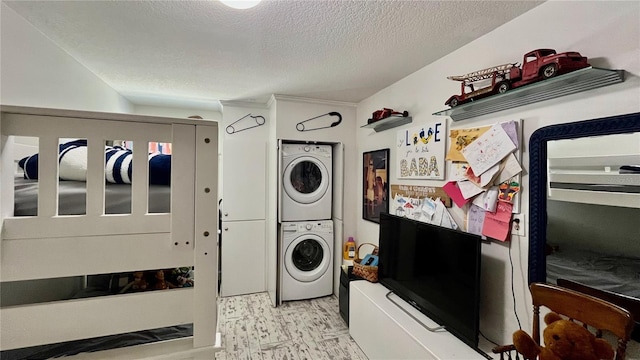 34 Richmond Dr, New Smyrna Beach, FL 32169 - laundry area featuring laundry area, stacked washer / drying machine, and a textured ceiling