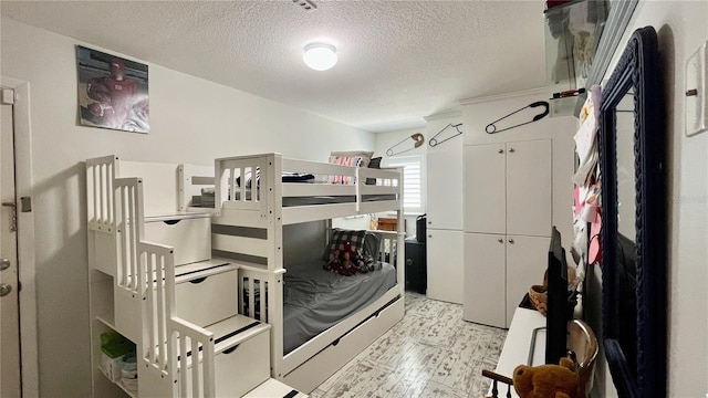 34 Richmond Dr, New Smyrna Beach, FL 32169 - bedroom featuring light floors and a textured ceiling