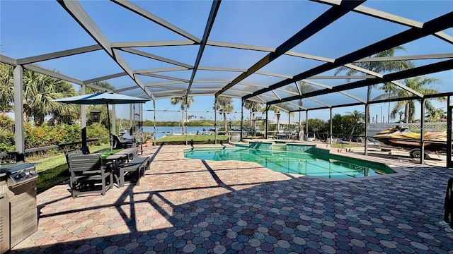 34 Richmond Dr, New Smyrna Beach, FL 32169 - view of swimming pool with a water view, glass enclosure, a patio, and a pool with connected hot tub