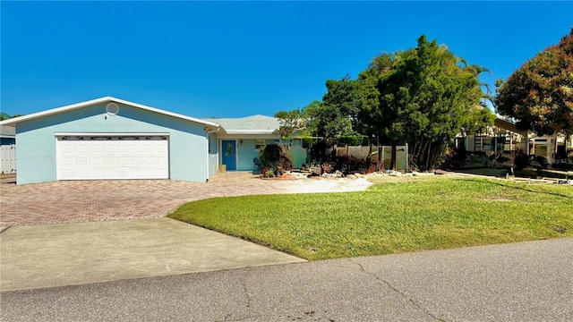 34 Richmond Dr, New Smyrna Beach, FL 32169 - single story home featuring stucco siding, a front lawn, an attached garage, and decorative driveway
