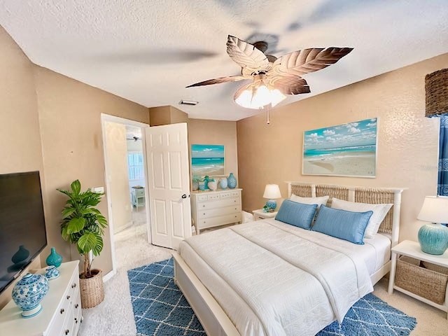 439 Bouchelle Dr Unit 202, New Smyrna Beach, FL 32169 - carpeted bedroom featuring a textured ceiling and a ceiling fan
