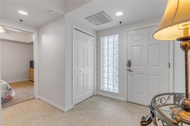 foyer with baseboards, light tile patterned floors, and recessed lighting