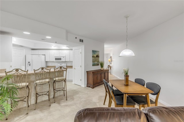 dining area featuring baseboards and recessed lighting