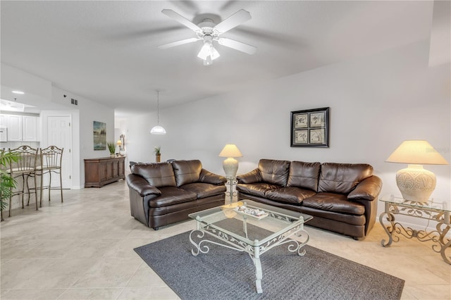 living room featuring light tile patterned floors and a ceiling fan
