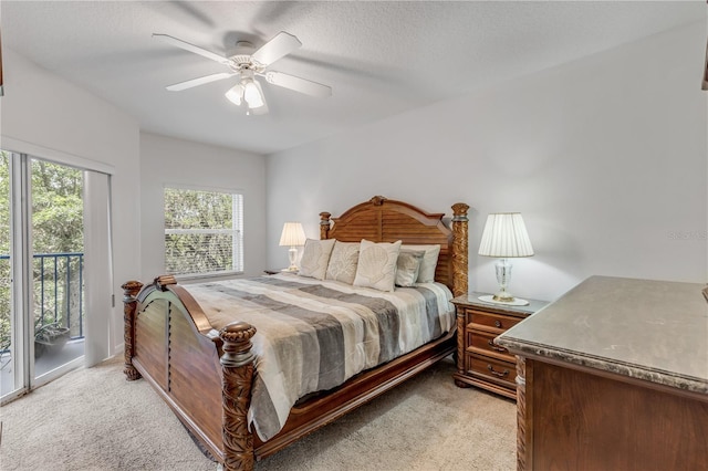 bedroom featuring access to outside, light carpet, and a ceiling fan