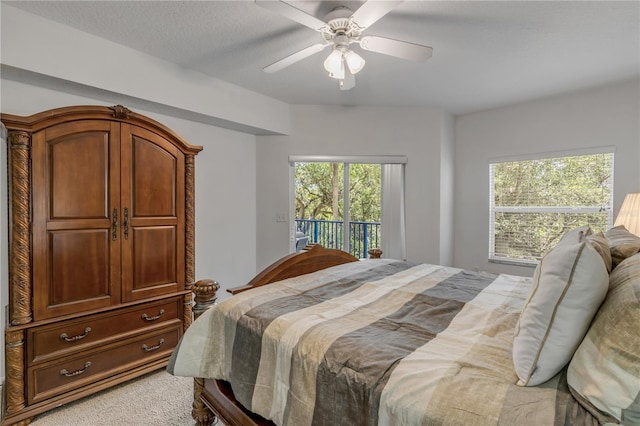 bedroom featuring access to outside, a ceiling fan, and light colored carpet