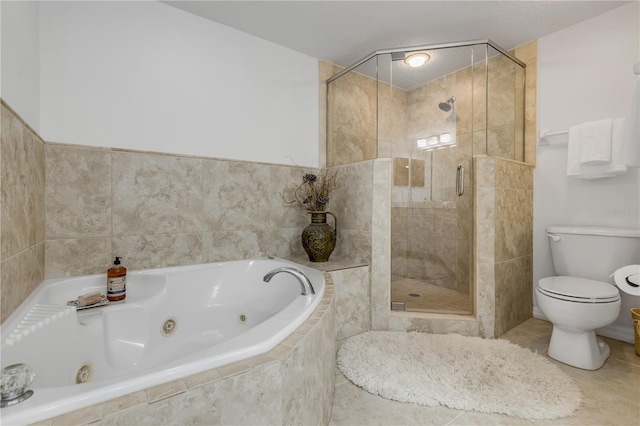 bathroom featuring a stall shower, a jetted tub, toilet, and tile patterned flooring