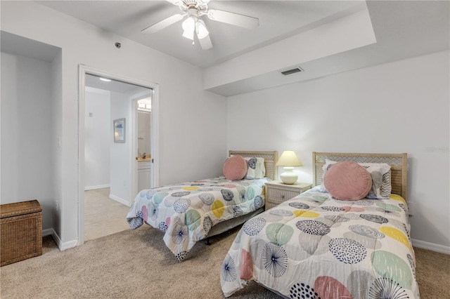 bedroom featuring carpet, baseboards, a ceiling fan, and ensuite bath