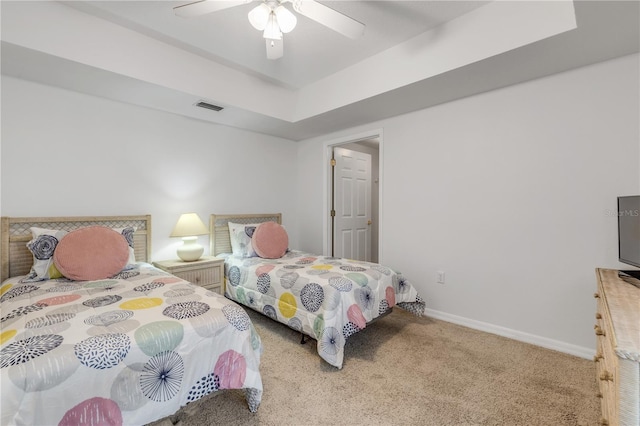 carpeted bedroom with ceiling fan and baseboards
