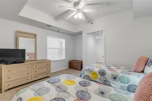 bedroom with light carpet, baseboards, and ceiling fan
