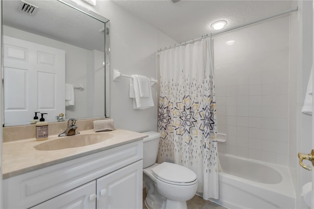 full bathroom featuring toilet, shower / bath combo, vanity, and a textured ceiling
