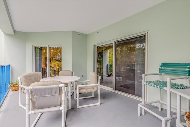 balcony featuring outdoor dining area and a patio area