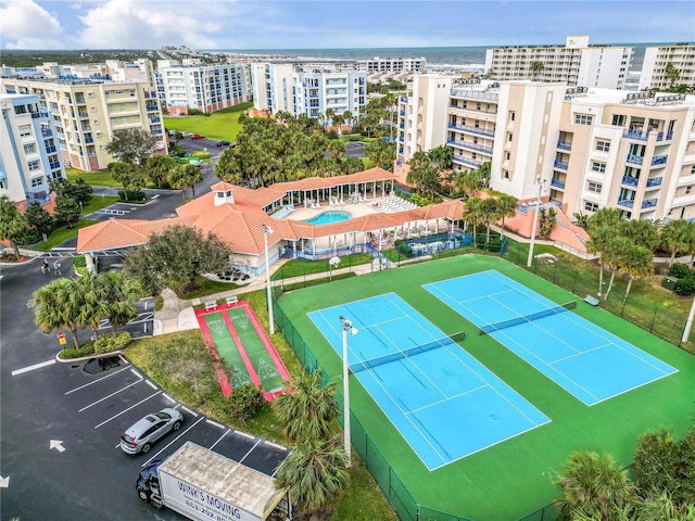 view of urban area featuring a pool area and apartment complex