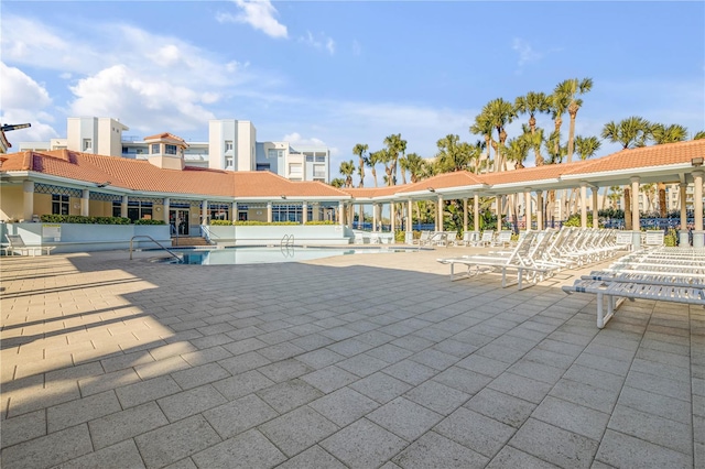 view of home's community featuring a pool and a patio