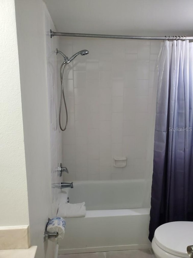 full bath featuring toilet and shower / bath combination with curtain