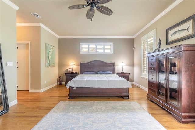 bedroom with multiple windows, light wood-type flooring, visible vents, and ornamental molding