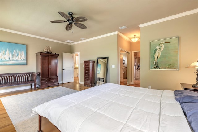 bedroom featuring crown molding, visible vents, wood finished floors, and ceiling fan