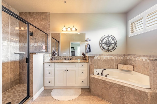 bathroom with a garden tub, vanity, tile patterned flooring, and a shower stall