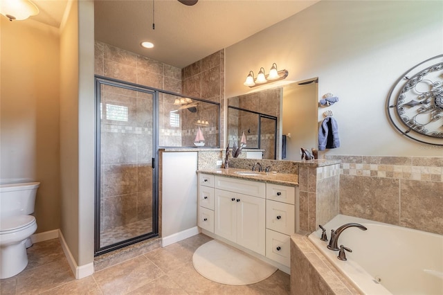bathroom featuring toilet, a shower stall, tile patterned flooring, a garden tub, and vanity