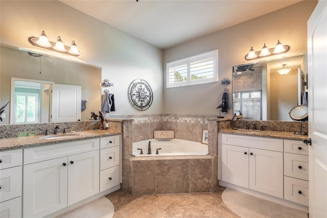full bathroom with tiled shower, plenty of natural light, a garden tub, and a sink