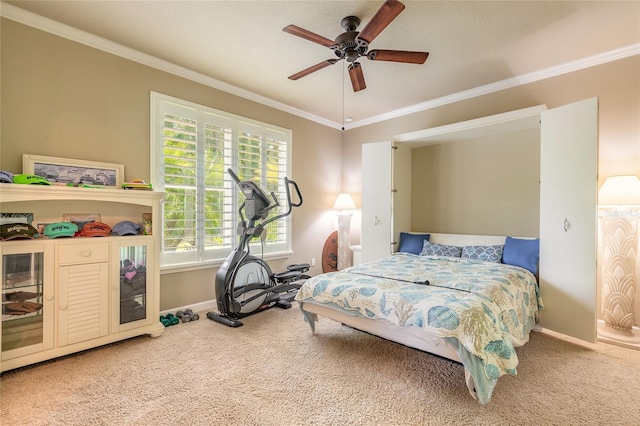 carpeted bedroom with baseboards, ornamental molding, and a ceiling fan